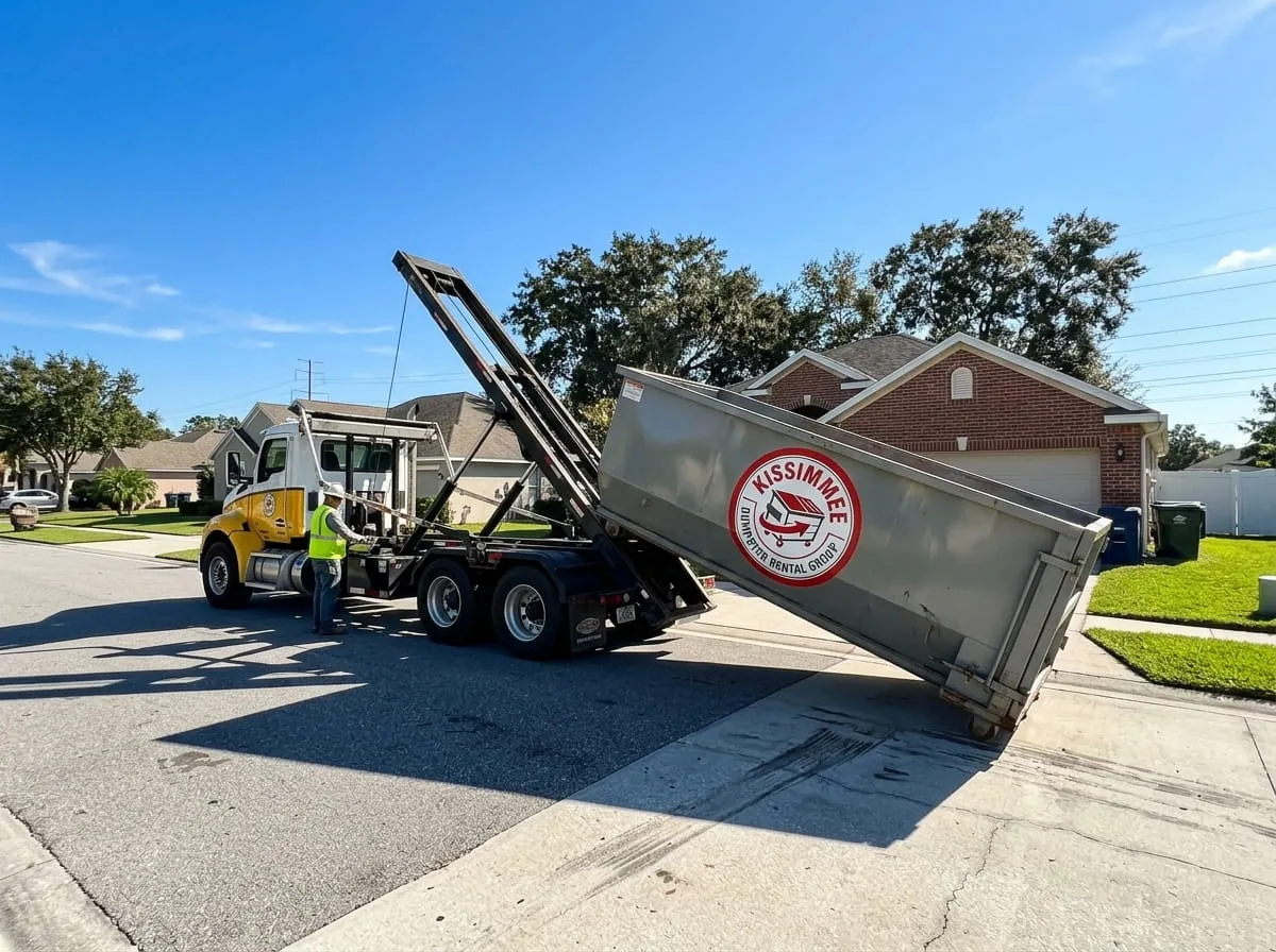 Roll-off truck lowering a red dumpster into position on a Kissimmee property Roll-off truck lowering a red dumpster into position on a Kissimmee property